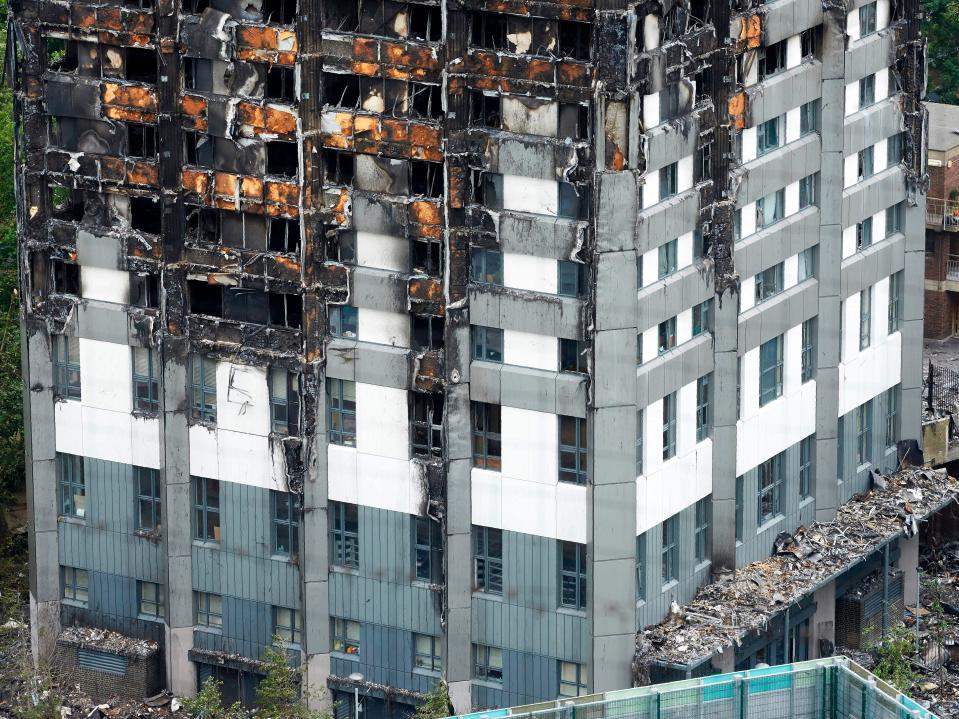 Remains of the tower’s unburned lower floors, with untouched cladding still in place, are pictured on 22 June 2017 – eight days after the fire (AFP via Getty Images)