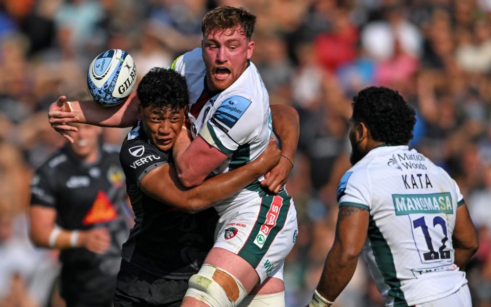 Ollie Chessum of Leicester Tigers is tackled by Greg Fisilau of Exeter Chiefs during the Gallagher Premiership Rugby match between Exeter Chiefs and Leicester Tigers at Sandy Park on September 21, 2024 in Exeter, England