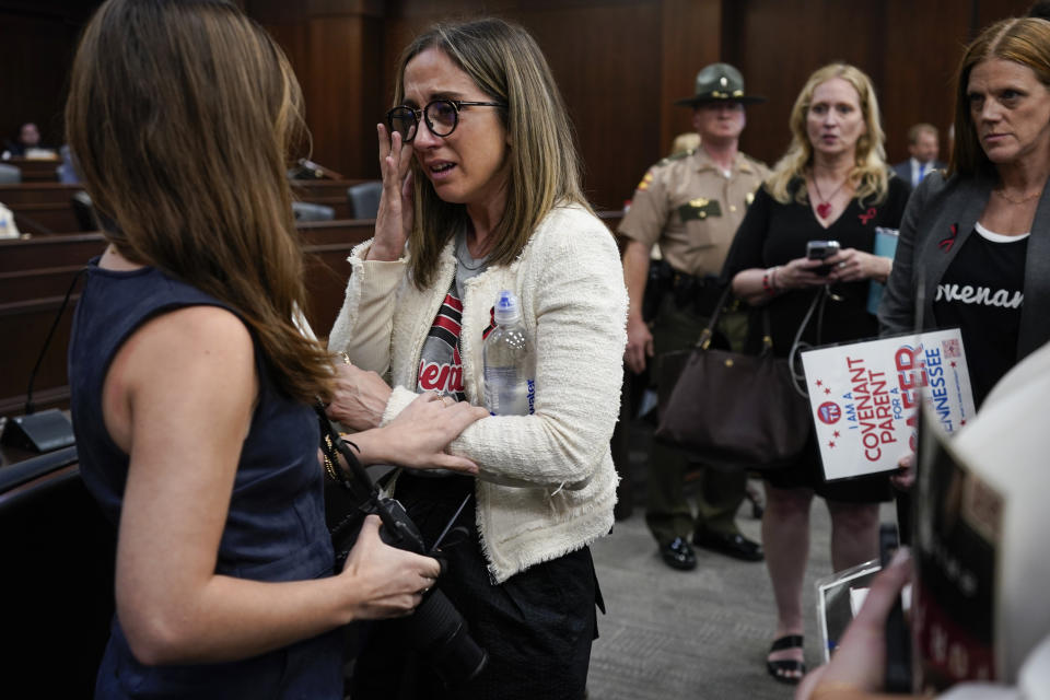 FILE - Covenant School parent Sarah Shoop Neumann, second from left, wipes tears as she and other members of the audience are removed from the House Civil Justice Subcommittee meeting by the Republican chairman during a special session of the state legislature on public safety, Tuesday, Aug. 22, 2023, in Nashville, Tenn. Throughout the corridors of many state Capitols, families are sharing emotionally gutting stories of tragedy caused by mass school shootings with the hope that revealing their trauma will convince lawmakers on either side of the political aisle to reconsider firearm policies. (AP Photo/George Walker IV, File)