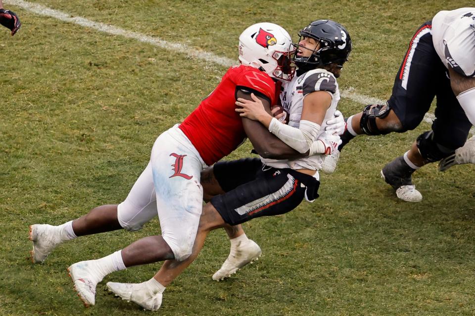 Cincinnati quarterback Evan Prater is sacked by Louisville's YaYa Diaby during the fourth quarter of Louisville's 24-7 win in the Fenway Bowl NCAA college football game at Fenway Park Saturday, Dec. 17, 2022, in Boston. Saturday, Dec. 17, 2022, in Boston. (AP Photo/Winslow Townson)