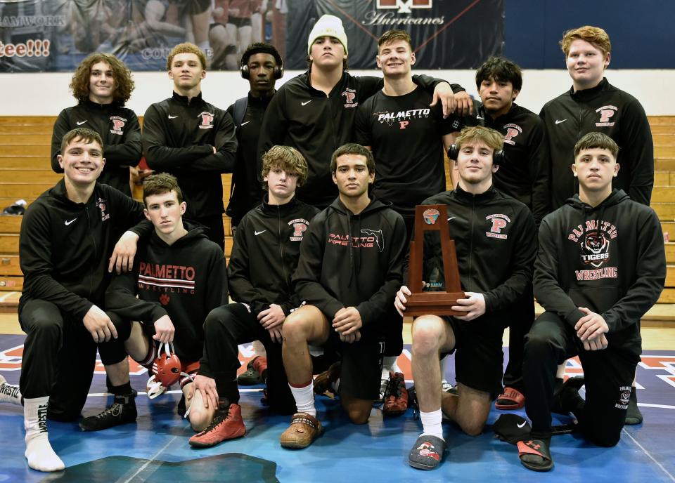 Taking second place the Palmetto Tigers wrestling team, back row, left to right: Colton Aaron (113), Aiden Carter (157), Dana Law (144), DeAndre Berry (285), Dastan Chiketaev (190), Josue Urita-Cruz (165) and Ryan Reid (215). Front row, left to right: Nevan Nadeau (150), Sean Herlihy (120), Michael Schlegel (106), Andre Shiffner (126), Jake Wyatt (138) and Robert McGill (132) on Friday at Manatee High in Bradenton. The Tigers will also advance to the 2A-Region 2 tournament, taking on host Jesuit in Round 1.