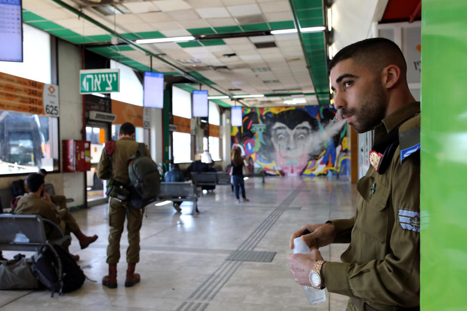 An Israeli soldier waits with others to board buses at the Central Bus Station on Feb. 3. (Photo: Corinna Kern/Reuters)