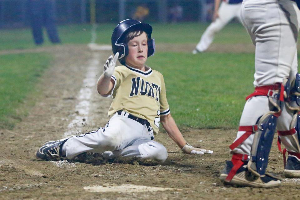 North Kingstown/Wickford's Will Clarke slides home during a five-run fourth inning in Monday night's Little League state tournament winners'-bracket final game.