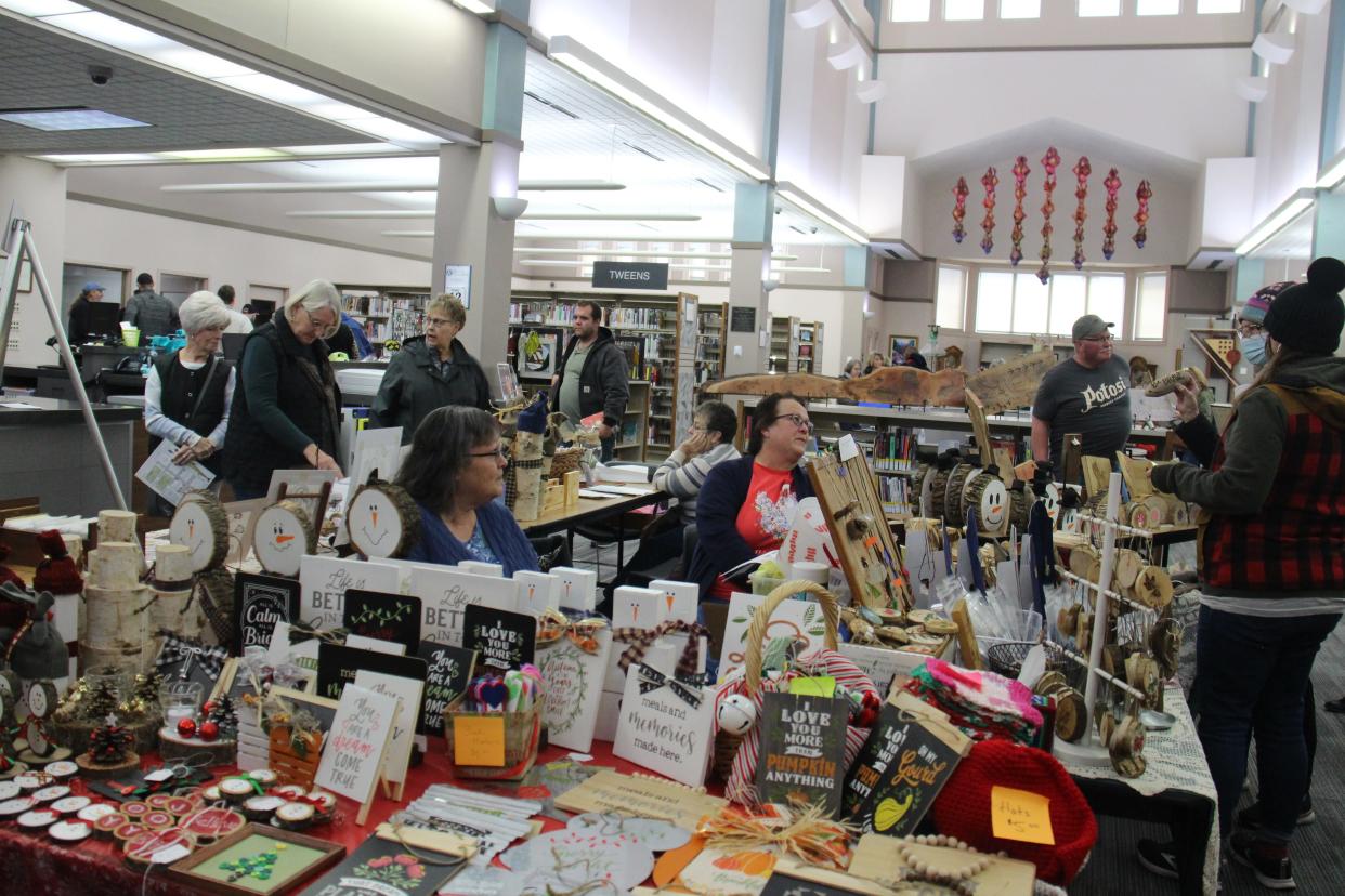 Shoppers browse the various artist booths during Art on the Prairie on Saturday, Nov. 13, 2021, at the Perry Public Library. Perry Public Library, as well as the Carnegie Library Museum, will be designated venues for visual and performing artists for the 2022 Art on the Prairie on Nov. 12-13.