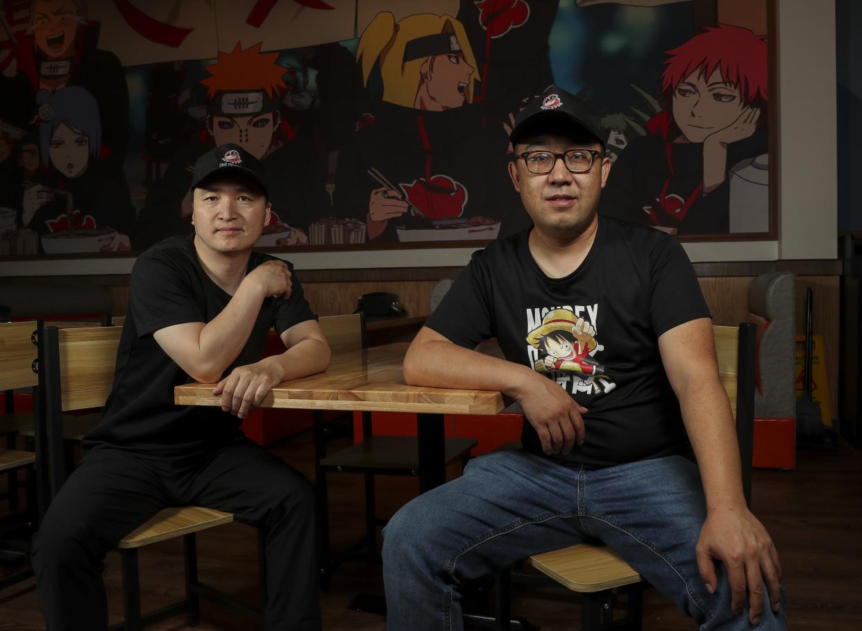 Leo Wu, left, and Tony Yu, right, pose for a portrait on Thursday, June 20, 2024, at Koi Poke & Ramen in Ashwaubenon, Wis.