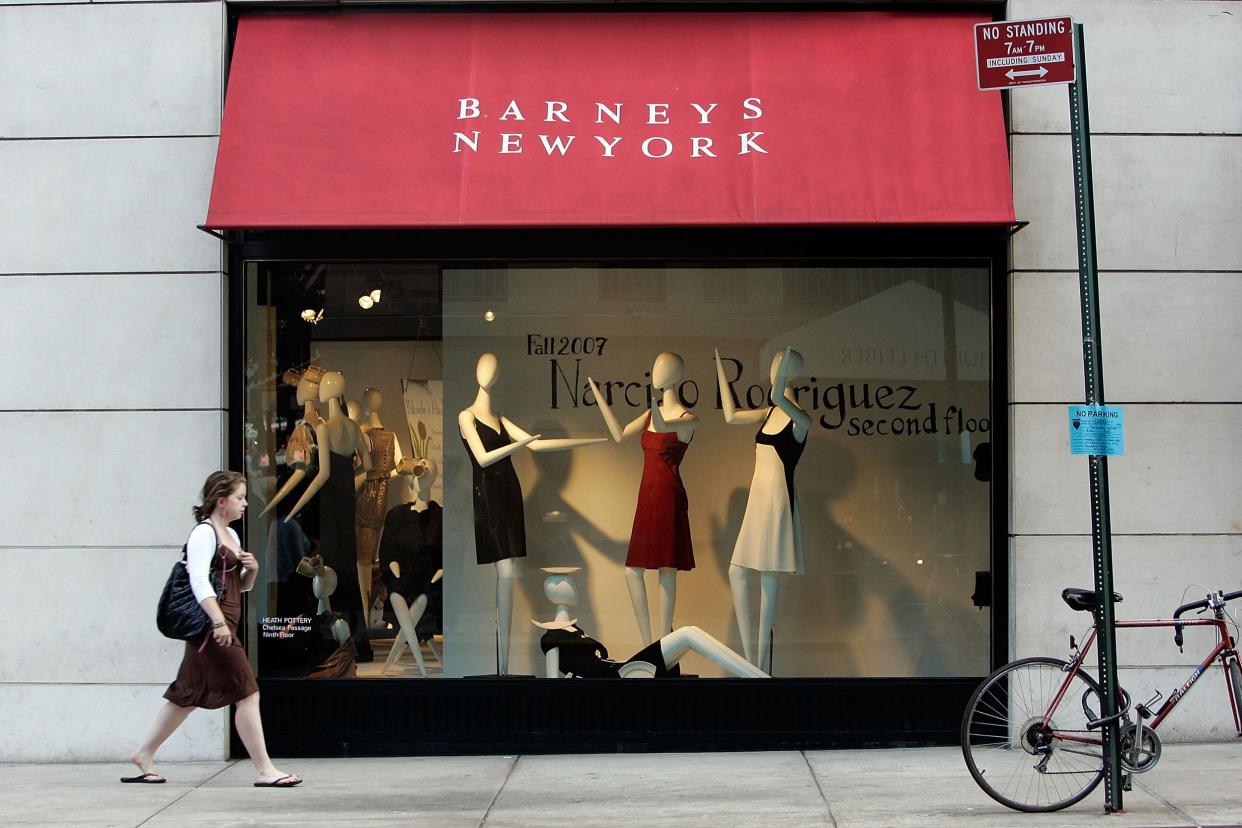 A woman walks past a Barneys New York store window June 22, 2007 in New York City.