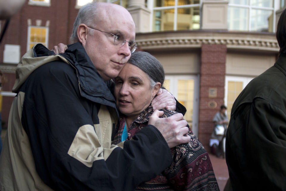 William Quigley and Michele Naar-Obed hug outside the Federal Courthouse after Naar-Obed's husband, Greg Boertje-Obed and two others were sentenced for the role they played in a July 2012 break-in at the Y-12 National Security Complex in Knoxville, Tenn., Tuesday, Feb. 18, 2014. Sister Megan Rice, 84, was sentenced to nearly three years in prison and Michael Walli and Greg Boertje-Obed were sentenced to more than five years in prison. The break-in raised questions about the safekeeping at the facility that holds the nation's primary supply of bomb-grade uranium. (AP Photo/The Knoxville News Sentinel, Saul Young)