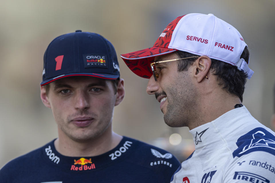 ABU DHABI, UNITED ARAB EMIRATES - NOVEMBER 26: Max Verstappen of the Netherlands and Oracle Red Bull Racing, and Daniel Ricciardo of Australia and Scuderia AlphaTauri look from the drivers parade prior to the F1 Grand Prix of Abu Dhabi at Yas Marina Circuit on November 26, 2023 in Abu Dhabi, United Arab Emirates. (Photo by Edmund So/Eurasia Sport Images/Getty Images)