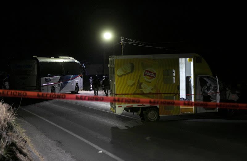 Police keep watch at a scene where 19 people were killed, in Zinapecuaro