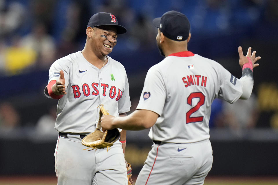 Boston Red Sox third baseman Rafael Devers, left, and first baseman Dominic Smith celebrate after the team defeated the Tampa Bay Rays during a baseball game Monday, May 20, 2024, in St. Petersburg, Fla. (AP Photo/Chris O'Meara)