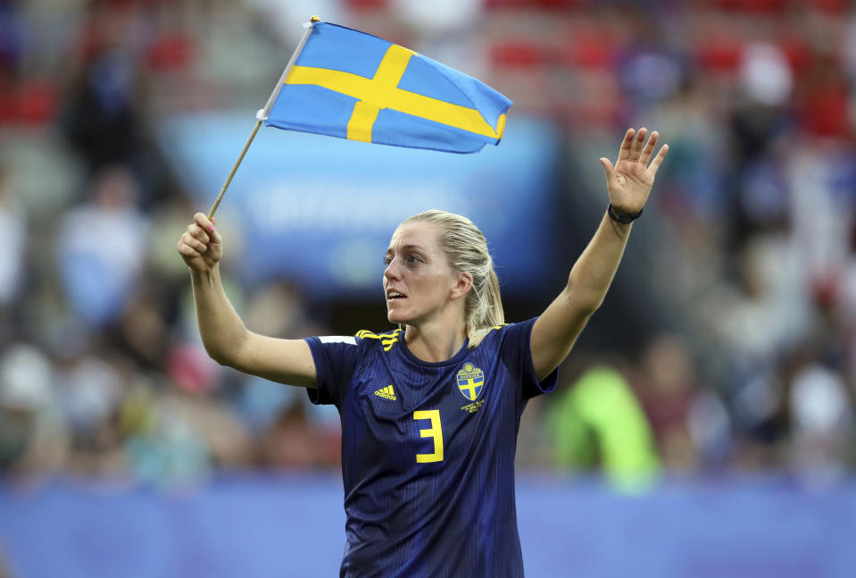 Sweden's Linda Sembrant waves her country national flag as she celebrates at the end of the Women's World Cup quarterfinal soccer match between Germany and Sweden at Roazhon Park in Rennes, France, Saturday, June 29, 2019. Sweden beat Germany 2-1. (AP Photo/David Vincent)