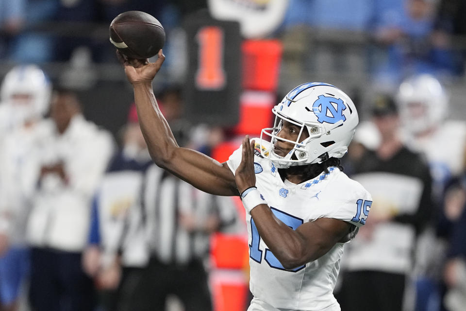 North Carolina quarterback Conner Harrell passes against West Virginia during the first half of an NCAA college football game at the Duke's Mayo Bowl Wednesday, Dec. 27, 2023, in Charlotte, N.C. (AP Photo/Chris Carlson)
