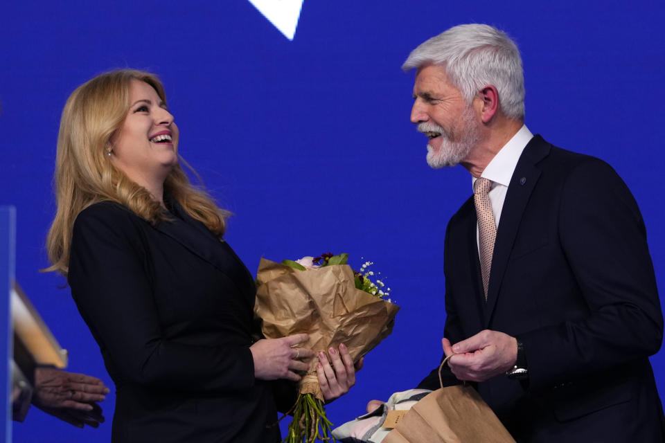 Czech Republic's President elect Petr Pavel smiles as he meets with Slovakia's President Zuzana Caputova after announcement of the preliminary results of the presidential runoff in Prague, Czech Republic, Saturday, Jan. 28, 2023. (AP Photo/Petr David Josek)