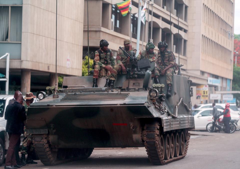 <p>A group of soldiers seal off a main road to the parliament building within the military activities taking place in Harare, Zimbabwe on Nov. 16, 2017. (Photo: Tafadzwa Ufumeli/Anadolu Agency/Getty Images) </p>