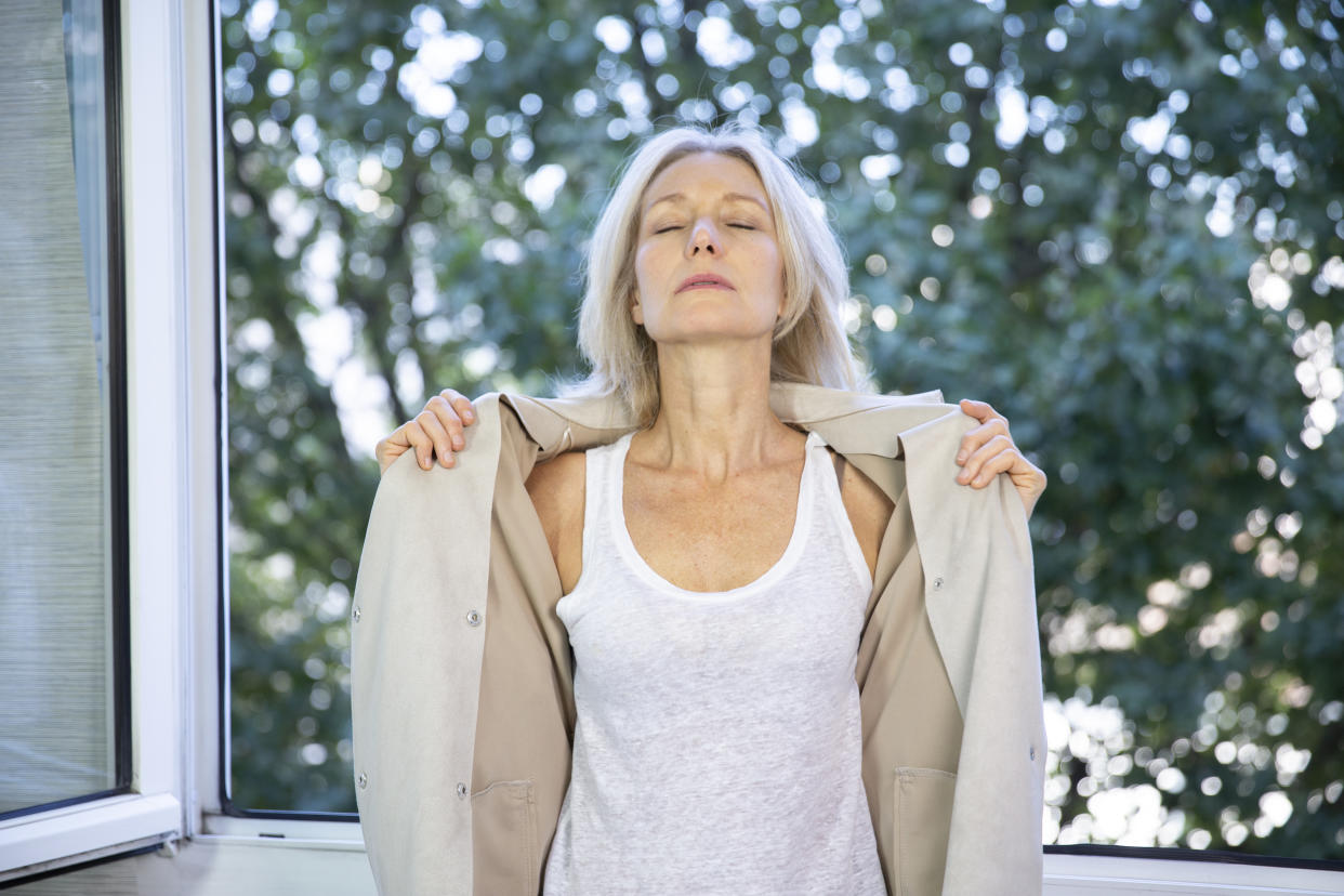 Older woman feeling really hot at home.