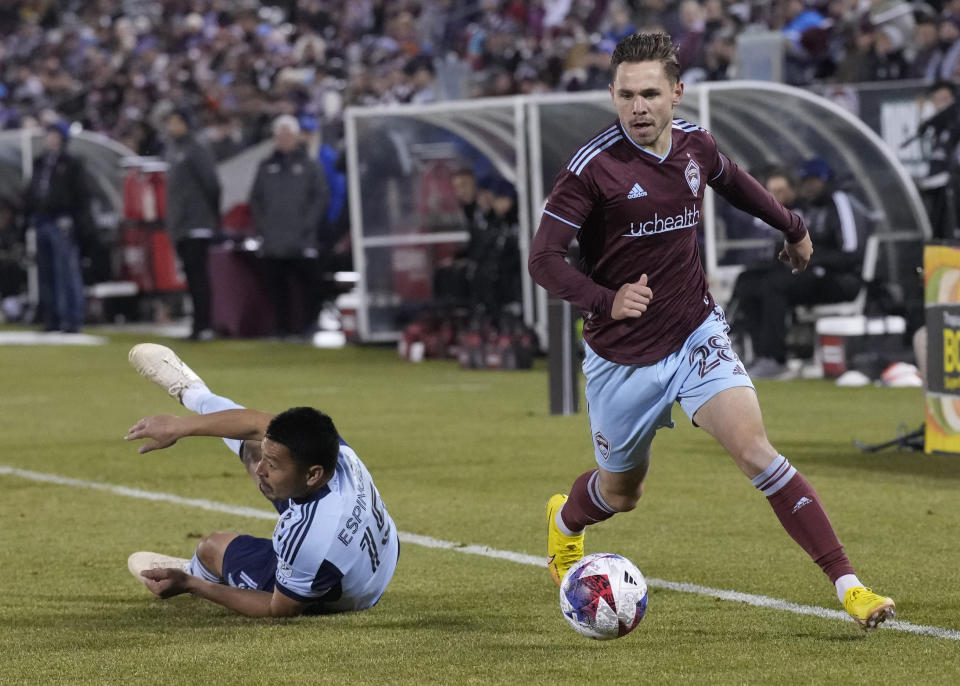 Colorado Rapids midfielder Sam Nicholson, right, drives past Sporting Kansas City midfielder Roger Espinoza during the first half of an MLS soccer match Saturday, March 4, 2023, in Commerce City, Colo. (AP Photo/David Zalubowski)