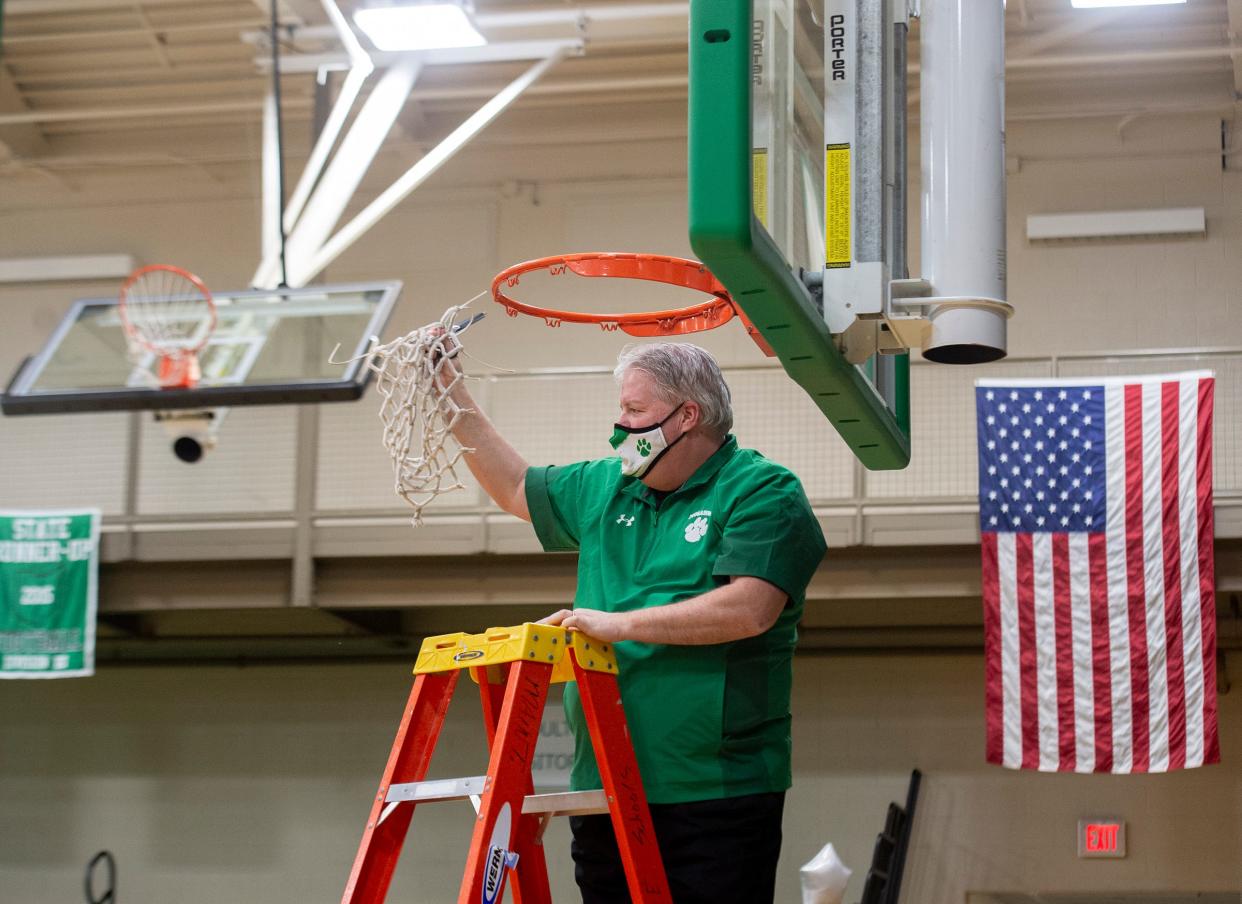 Mogadore defeats Southeast 59-47 for the Portage Trail Conference championship. Wildcats head coach Russ Swartz cuts down the net.