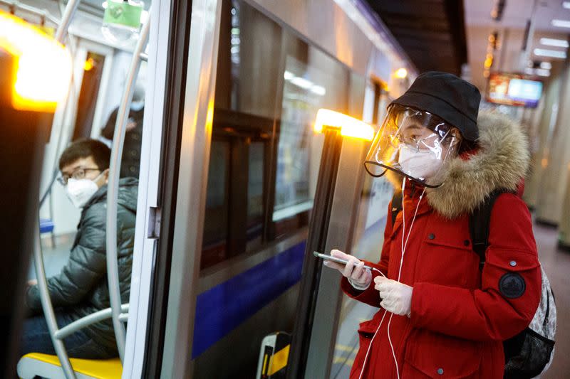 People wear face masks on the metro in Beijing as the country is hit by an outbreak of the novel coronavirus