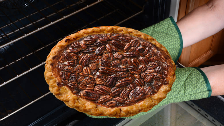 removing pecan pie from oven