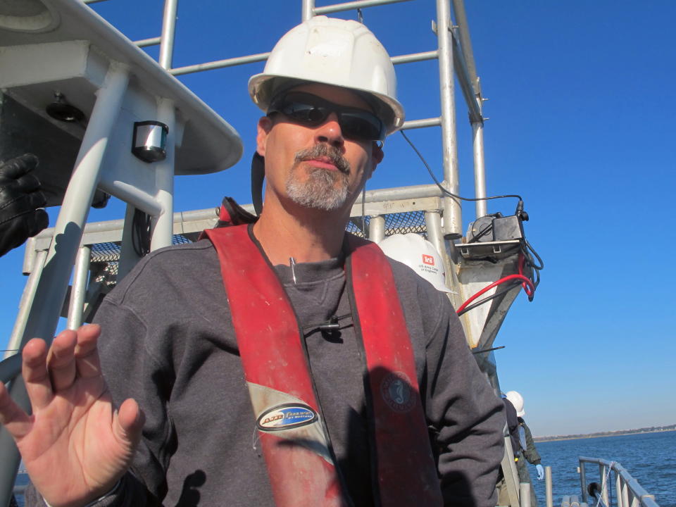 Terry Cake, the vice president of Anamar Environmental Consulting, discusses work to take sediment samples from the harbor in Charleston, S.C., on Friday, Nov. 9, 2012. Cake was aboard a boat in the harbor taking samples required for a study of a $300 million deepening of the harbor shipping channel so it can handle larger container ships. (AP Photo/Bruce Smith).