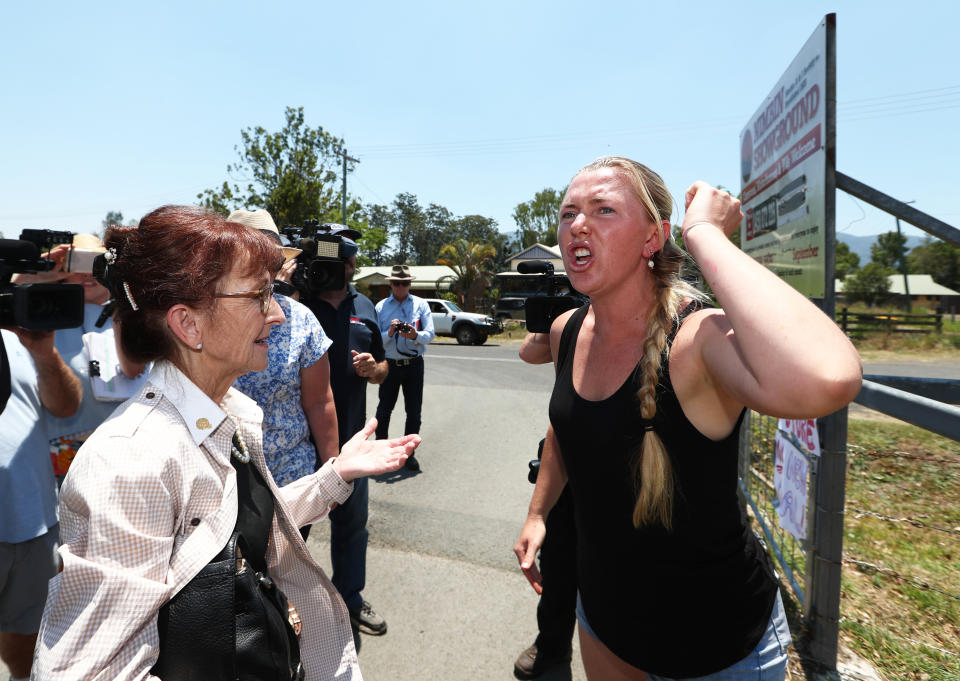 Local Resident Ginger O'Brien raises her hand and shouts at Member for Lismore Janell Saffin in the bushfire affected area of Nimbin, NSW.