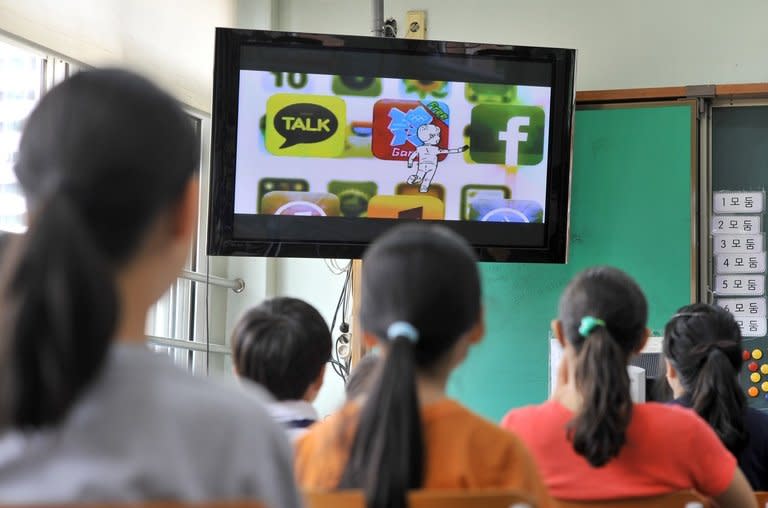 Children watch TV during a special class on smartphone addiction, at an elementary school in Seongnam, south of Seoul, on June 11, 2013. South Korea, after boasting for years advanced technology from high-speed Internet to Samsung smartphones, is now taking pains to try to pull its tech-crazed youth away from digital addiction