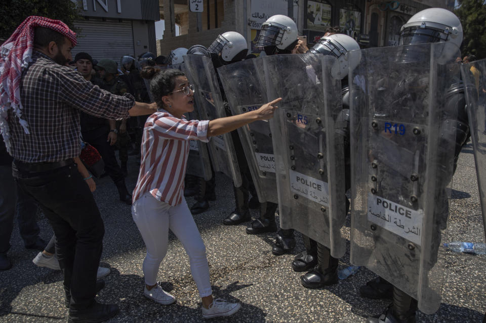 Riot police block angry demonstrators from marching to the Palestinian Authority's headquarters before dispersing them, during a rally protesting the death of Nizar Banat, an outspoken critic of the PA, in the West Bank city of Ramallah, Thursday June 24, 2021. Banat who was a candidate in parliamentary elections called off earlier this year died after Palestinian security forces arrested him and beat him with batons on Thursday, his family said. (AP Photo/Nasser Nasser)