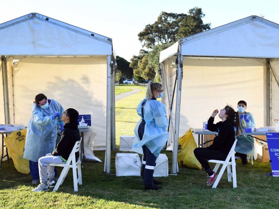 People have swab samples taken during testing for the COVID-19 coronavirus in a suburban park in Melbourne: AFP via Getty Images