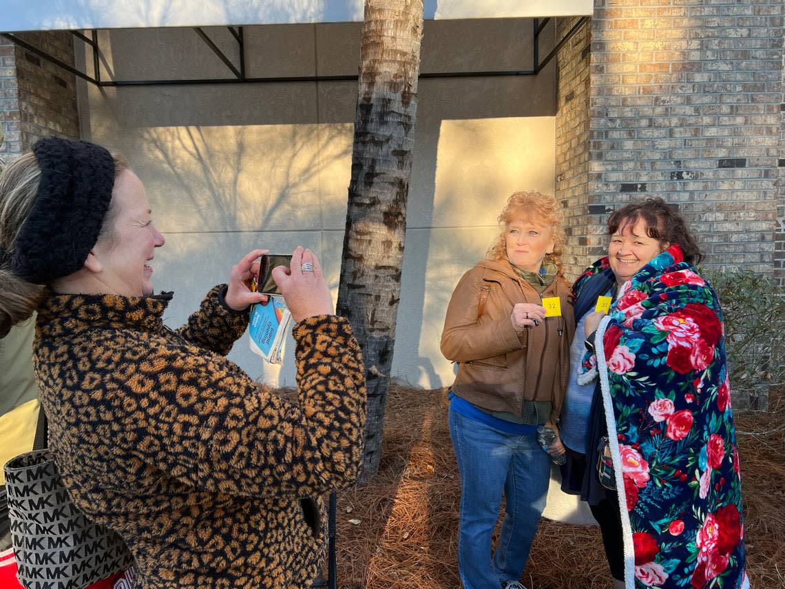Diana Bosse of Hilton Head takes a photo of Jacquie Egan of Bluffton and Bette Vost of New York in line at the new Aldi store on Fording Island Road in Bluffton on Jan. 26, 2023. They had been in line on a chilly morning waiting for the grand opening.