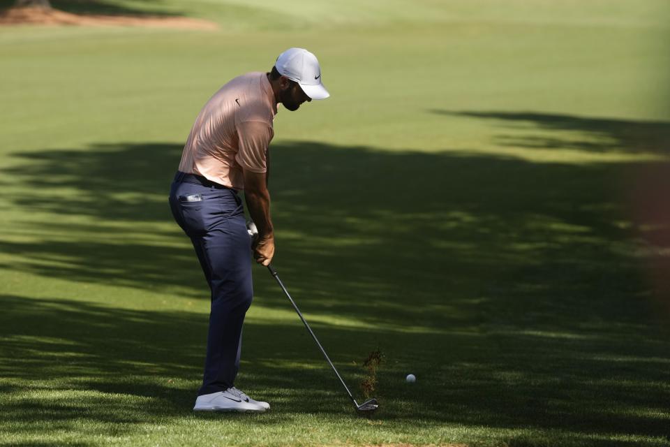 Scottie Scheffler hits from the second cut on the seventh hole during final round at the Masters golf tournament at Augusta National Golf Club Sunday, April 14, 2024, in Augusta, Ga. (AP Photo/Charlie Riedel)