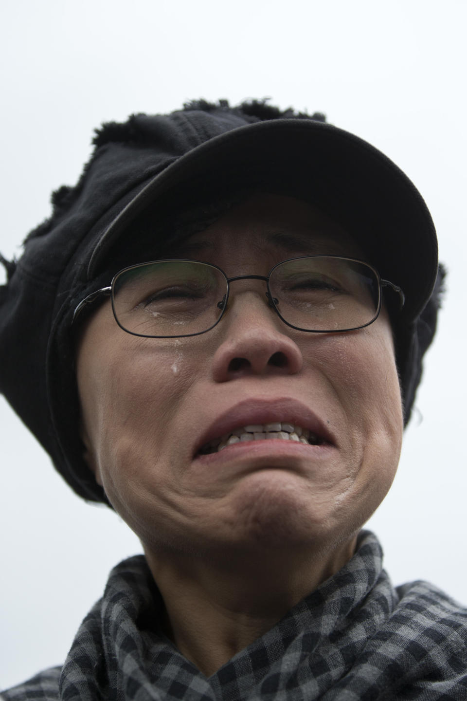 FILE - In this June 9, 2013 file photo, Liu Xia, the wife of imprisoned Nobel Peace Prize winner Liu Xiaobo, cries outside Huairou Detention Center where her brother Liu Hui has been jailed in Huairou district, on the outskirts of Beijing, China. The health of Liu Xia has deteriorated under lengthy house arrest and she urgently requires medical treatment, close friends said Friday, Feb. 14, 2014. (AP Photo/Alexander F. Yuan, File)