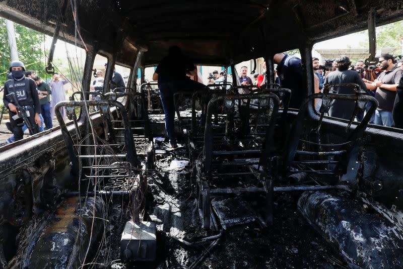 A general view shows a passenger van after a blast at the entrance of the Confucius Institute University of Karachi