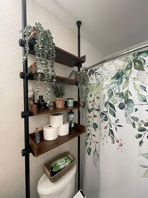 Over-the-toilet shelves with a tension rod design supporting them from the floor to the ceiling