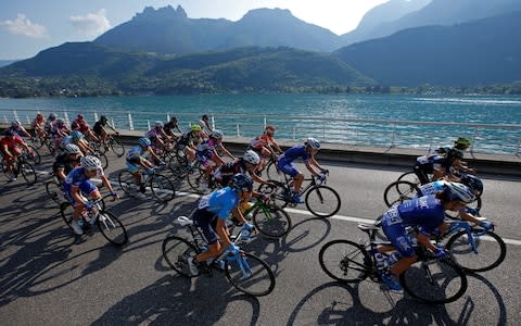 A group of female cyclists ride past a lake during the 5th La Course by Le Tour de France - Credit: REUTERS