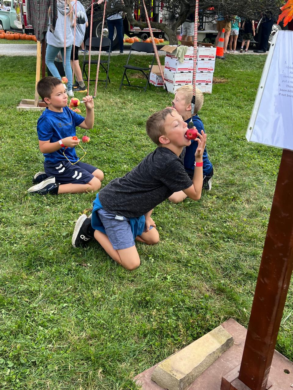 Catching an apple on a string is one of the activities at the Case-Barlow Farm fall festival.