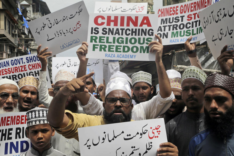 FILE - In this Sept. 14, 2018, file photo, Indian Muslims shout slogans in support of minority Uighur Muslim ethnic groups in detention and political indoctrination centers in China. Members of the Uighur Muslim ethnic group are calling on China to post videos of their relatives who have disappeared into a vast system of internment camps. The campaign follows the release of a state media video showing famed Uighur musician Abdurehim Heyit, who many believed had died in custody. (AP Photo/Rajanish Kakade, File)