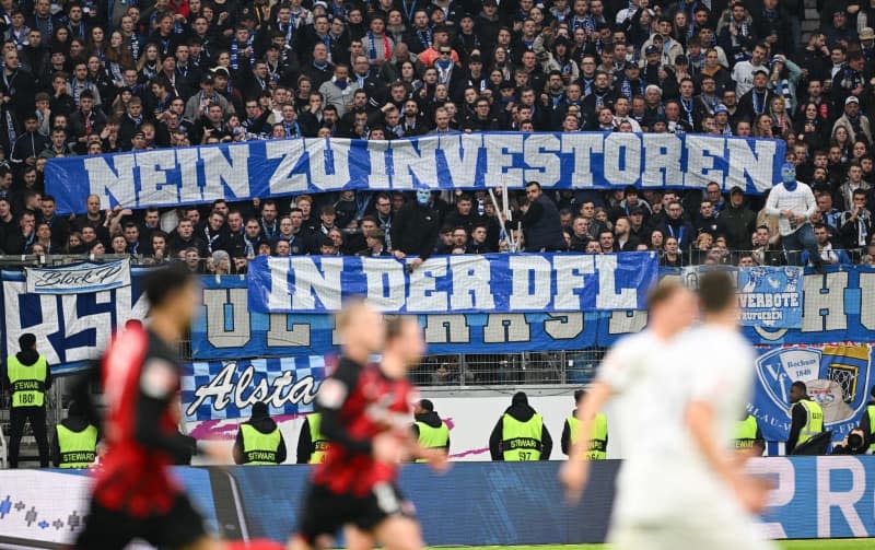 Bochum fans protest with posters reading "No to investors in the DFL" during the German Bundesliga soccer match between Eintracht Frankfurt and VfL Bochum at Deutsche Bank Park. Arne Dedert/dpa