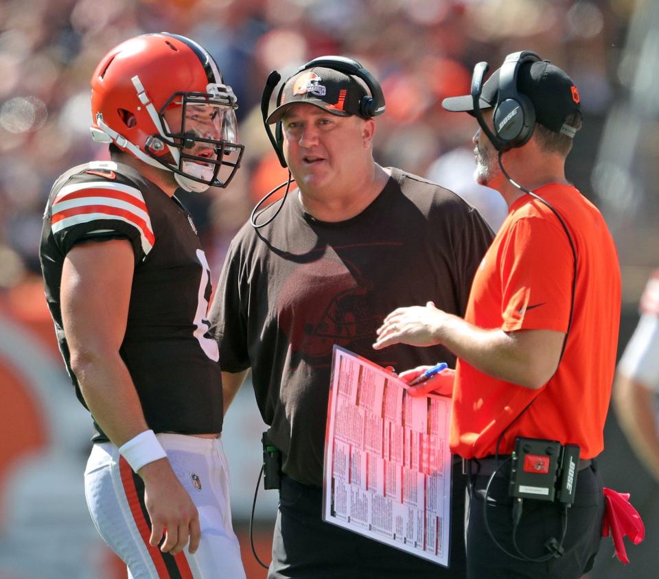 Cleveland Browns quarterback Baker Mayfield (6) meets with offensive coordinator Alex Van Pelt, center, and coach Kevin Stefanski during the first half against the Houston Texans on Sept. 19, 2021, in Cleveland.