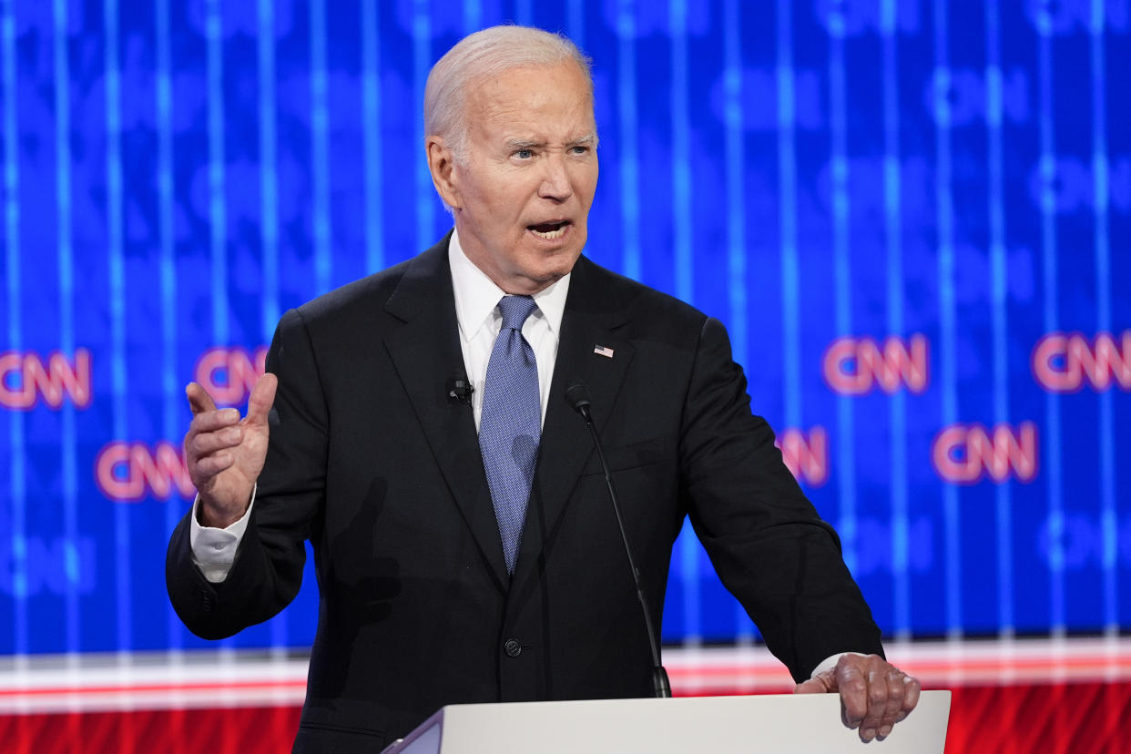 Biden speaks at a podium.