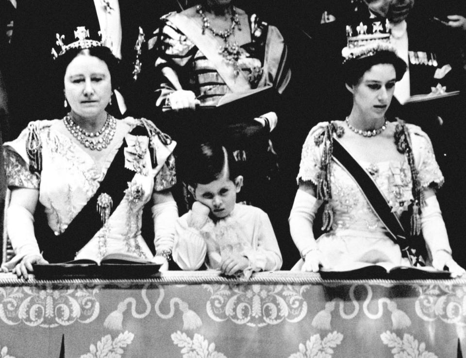 Prince Charles looking solemn as he stands between the Queen Mother and Princess Margaret in the Royal Box at Westminster Abbey, from where he watched the Queen crowned (PA/PA Wire)