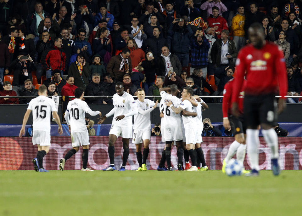 Valencia midfielder Carlos Soler celebrates with teammates after scoring his side's opening goal during a Group H Champions League soccer match between Valencia and Manchester United at the Mestalla Stadium in Valencia, Spain, Wednesday, Dec. 12, 2018. (AP Photo/Alberto Saiz)