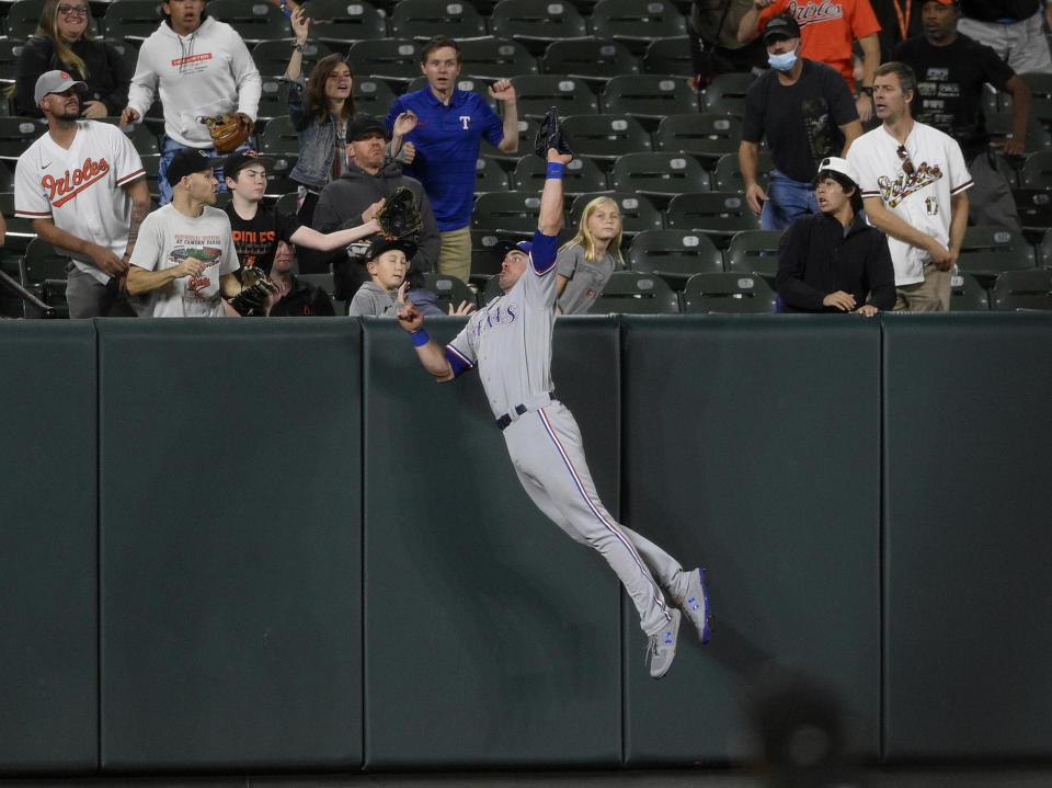 Texas Rangers left fielder DJ Peters makes a catch on a fly ball hit by Baltimore Orioles' Pat Valaika for an out during the fourth inning of a baseball game, Friday, Sept. 24, 2021, in Baltimore. (AP Photo/Nick Wass)