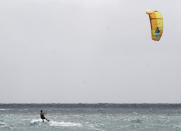 Michael Dixon takes advantage of the rising winds due to the approach of Tropical Storm Zeta as he kite surfs off Playa del Carmen, Mexico, Monday, Oct. 26, 2020. A strengthening Tropical Storm Zeta is expected to become a hurricane Monday as it heads toward the eastern end of Mexico's resort-dotted Yucatan Peninsula and then likely move on for a possible landfall on the central U.S. Gulf Coast at midweek. (AP Photo/Tomas Stargardter)