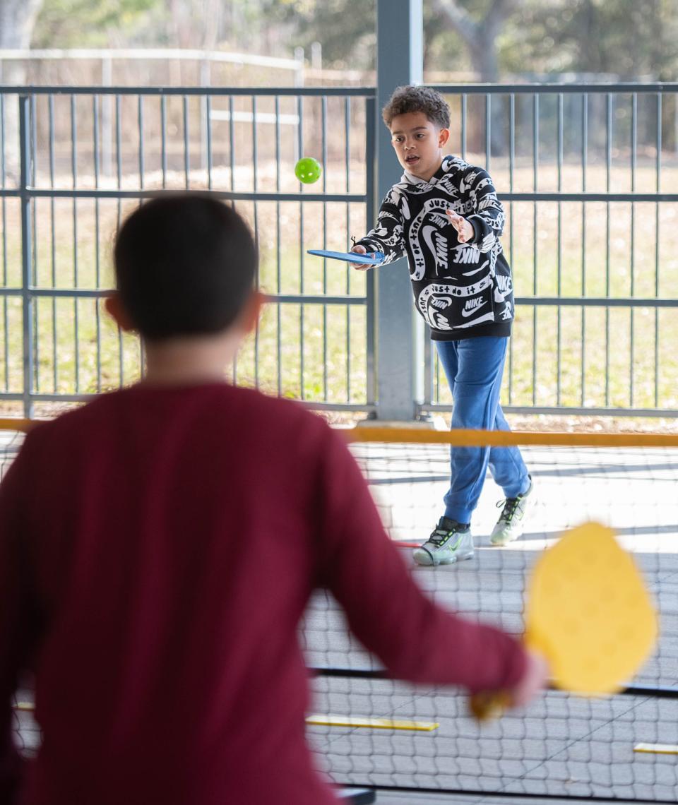 Johan Figueroa, 10, top, plays pickleball at Ferry Pass Elementary School in Pensacola on Wednesday, Feb. 21, 2024.