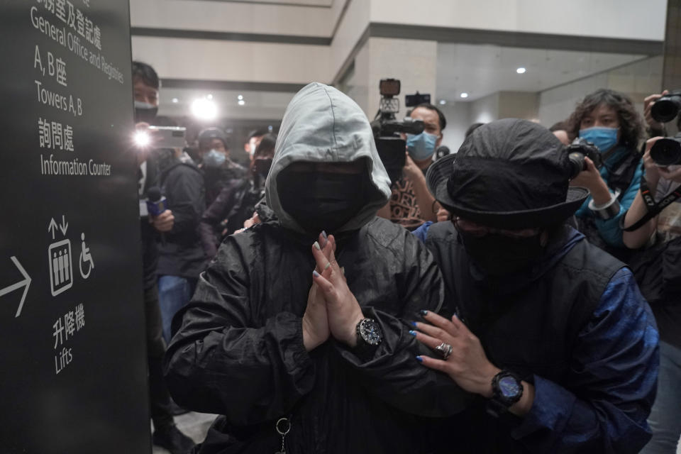 Supporters of one of the 47 pro-democracy activists react outside a court in Hong Kong Thursday, March 4, 2021. A Hong Kong court on Thursday remanded all 47 pro-democracy activists charged under a Beijing-imposed national security law in custody, ending a four-day marathon court hearing. (AP Photo/Kin Cheung)