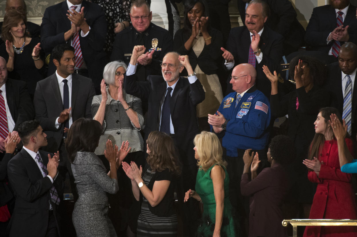 UNITED STATES - JANUARY 20: Alan Gross, a guest of the First Lady Michelle Obama, lower left, is recognized in the Capitol's House chamber during President Barack Obama's State of the Union address, January 20, 2015. Gross was imprisoned in Cuba for five years. (Photo By Tom Williams/CQ Roll Call)
