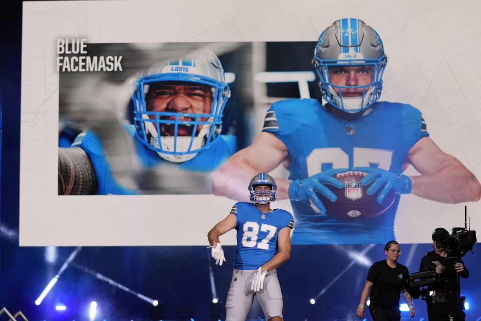 Detroit Lions tight end Sam LaPorta shows off team's new home jersey during an unveiling at Ford Field. (AP Photo/Carlos Osorio)