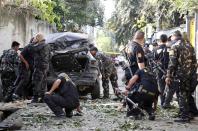 Police inspect the scene of a mortar attack by Muslim rebels of Moro National Liberation Front (MNLF) in downtown Zamboanga city in southern Philippines September 16, 2013. (REUTERS/Erik De Castro)