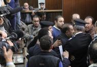 Members of the Muslim Brotherhood argue with policemen during the trial of the Brotherhood leaders in a courtroom in Cairo December 11, 2013. Prominent members of the Brotherhood were arrested in a state crackdown on the group following the army overthrow of President Mohamed Mursi and are charged with perpetrating violence during July's clashes. (REUTERS/Stringer)