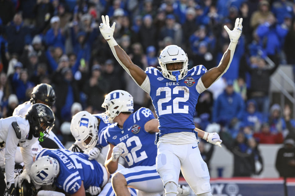 Duke running back Jaylen Coleman (22) reacts to a rushing touchdown score by quarterback Riley Leonard during the first half of the Military Bowl NCAA college football game against UCF, Wednesday, Dec. 28, 2022, in Annapolis, Md. (AP Photo/Terrance Williams)